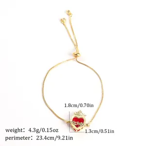 Gold-plated adjustable chain bracelet featuring a red heart pendant with crown design, elegant.