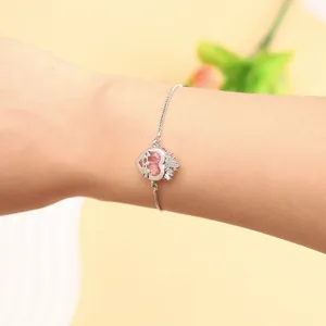 Silver adjustable bracelet featuring a sparkling pink heart zirconia charm with crown design.