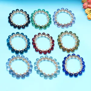 Close-up detail of colorful crystal ball bracelets set, faceted round beaded elastic fashion jewelry.