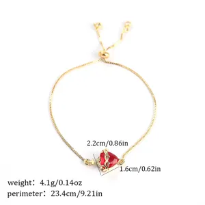 Detail view of the red cubic zirconia heart pendant bracelet with adjustable gold chain.