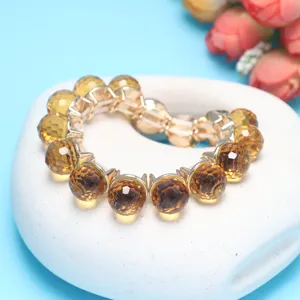 Yellow faceted crystal ball bracelet with gold tone links elegant jewelry design item.