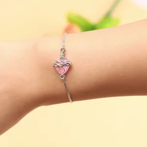 Exquisite pink zircon heart bracelet with crown detail, adjustable silver chain for women.