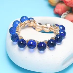 Blue crystal ball bracelet detail, faceted bead charm and elastic rope design for daily wear.