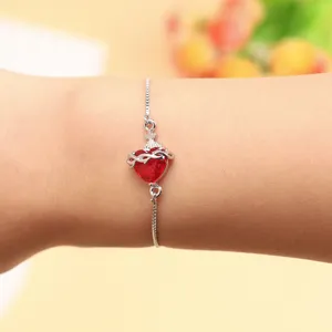 Detailed close-up of a red zircon heart bracelet with adjustable chain and elegant style.