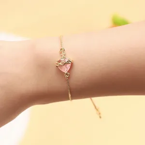 Gold tone pink heart crystal adjustable bracelet, delicate wrist jewelry for women daily wear.