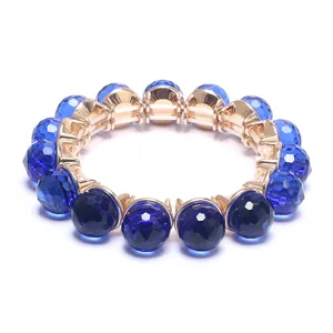Dark blue faceted crystal bead bracelet with gold tone settings and elastic cord design.