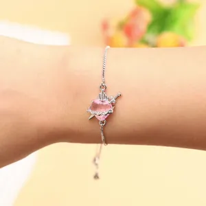 Silver tone adjustable bracelet featuring a pink heart and dagger pendant for women style.