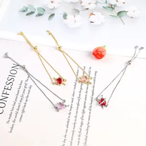 Detail view of delicate red and pink zircon heart slider bracelets with adjustable chains.