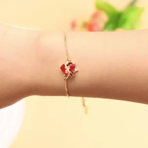 Elegant red cubic zirconia heart bracelet with adjustable gold chain, perfect gift.