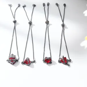 Detailed view of four minimalist red zircon heart charm bracelets with black adjustable chains.