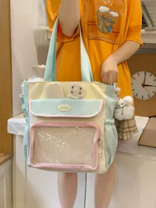 Japanese style sweet Ita bag in pastel colors held by a model in a casual setting.