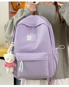 Vista dettagliata dello zaino scolastico viola semplice con un ciondolo a orsetto