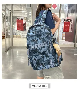 Detailed view of blue camouflage student backpack featuring star patterns and MGDCH logo strap