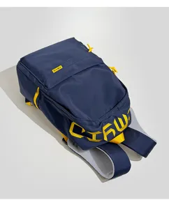 Detail view of navy blue backpack featuring yellow TIMYID label and embroidered letters