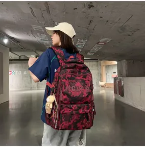 Stylish camouflage graffiti large capacity school backpack shown on a female model