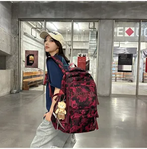 Street style view of a large burgundy camouflage backpack for students and travel