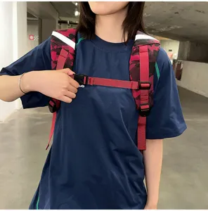 Close-up detail of camo backpack chest strap and safety buckle for high school students