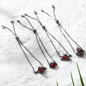 Red zircon heart and crown charm bracelet details, elegant black adjustable chain for women.