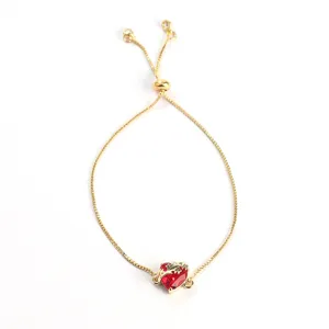 Gold adjustable slider bracelet featuring a sparkling red zirconia heart for women.