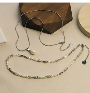 Close-up of natural freshwater pearl necklace set with silver bamboo-style accents