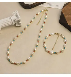 Macro view of a natural freshwater pearl, turquoise, and agate necklace and bracelet set.