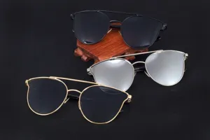 Detail view showing three colors of oversized fashion sunglasses on dark background