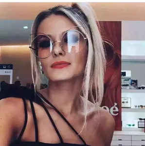 Close-up of model wearing oversized cat-ear round sunglasses for street style