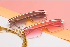 Macro view of gradient oversized shield sunglasses with gold-tone top bar design