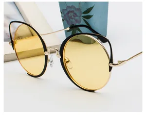 Retro cat-ear sunglasses with stylish yellow lenses and gold metal frame details.