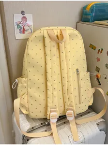 Vista trasera detallada de la mochila escolar amarilla con corazones y correas