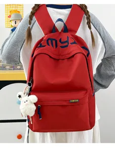 Stylish red student backpack with embroidered letters and a cute plush sheep pendant