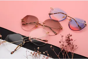 Detailed view of three pairs of rimless polygonal sunglasses with colorful gradient ocean lenses