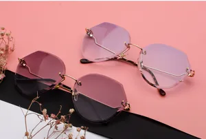 Detail view of oversized polygonal rimless sunglasses featuring gradient oceanic lenses