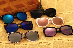 Assorted stylish large frame cat-ear sunglasses displayed on vintage newspaper background