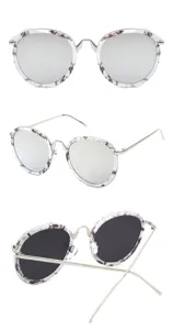 Macro detail showing round marble-patterned sunglasses with premium silver metal temples