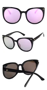 Detailed views of oversized cat-eye sunglasses in black frame with pink and brown lenses.