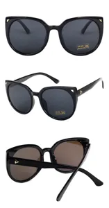 Detailed macro view of oversized cat-eye sunglasses with luxury gold triangle accents