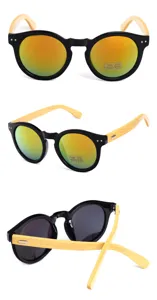 Detail view of round sunglasses with natural bamboo temples and orange mirrored lenses
