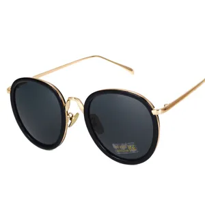 Fashionable oversized round sunglasses featuring black frames and gold metal temples