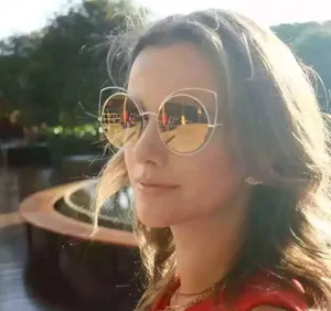 Oversized round sunglasses with gold metal cat ear frames for women in outdoor lifestyle