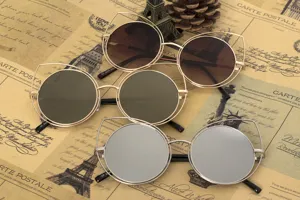Trendy cat-ear round sunglasses in various lens colors with metal frames for street style.