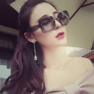 Professional model wearing large square gradient sunglasses with a stylish sparkling frame