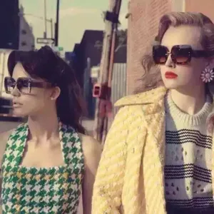 Detail view of retro large frame sunglasses worn by fashion models in street style