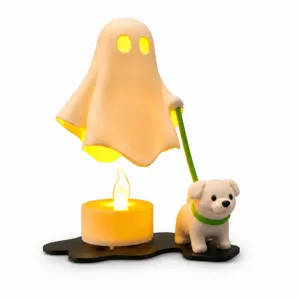 Close-up detail of Halloween ghost walking dog night light ornament with glowing candle base.
