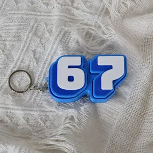 Detail view of the blue and white number 67 fidget clicker keychain with metal ring.