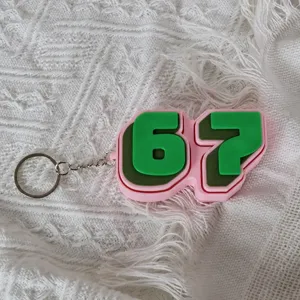 Pink and green number 67 fidget clicker keychain, cute silicone stress relief backpack pendant.
