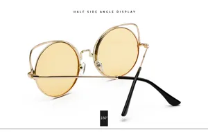 Close-up of vintage cat-ear sunglasses with yellow lenses, gold frame, shown at a side angle