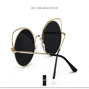 Detail view of retro cat-ear metal sunglasses with black lenses and gold frame