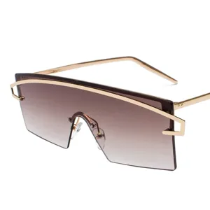 Oversized shield sunglasses with gold metal frame and gradient brown lenses for fashion