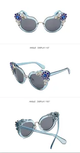 Detailed view of ornate light blue sunglasses with flower rhinestone pattern from multiple angles